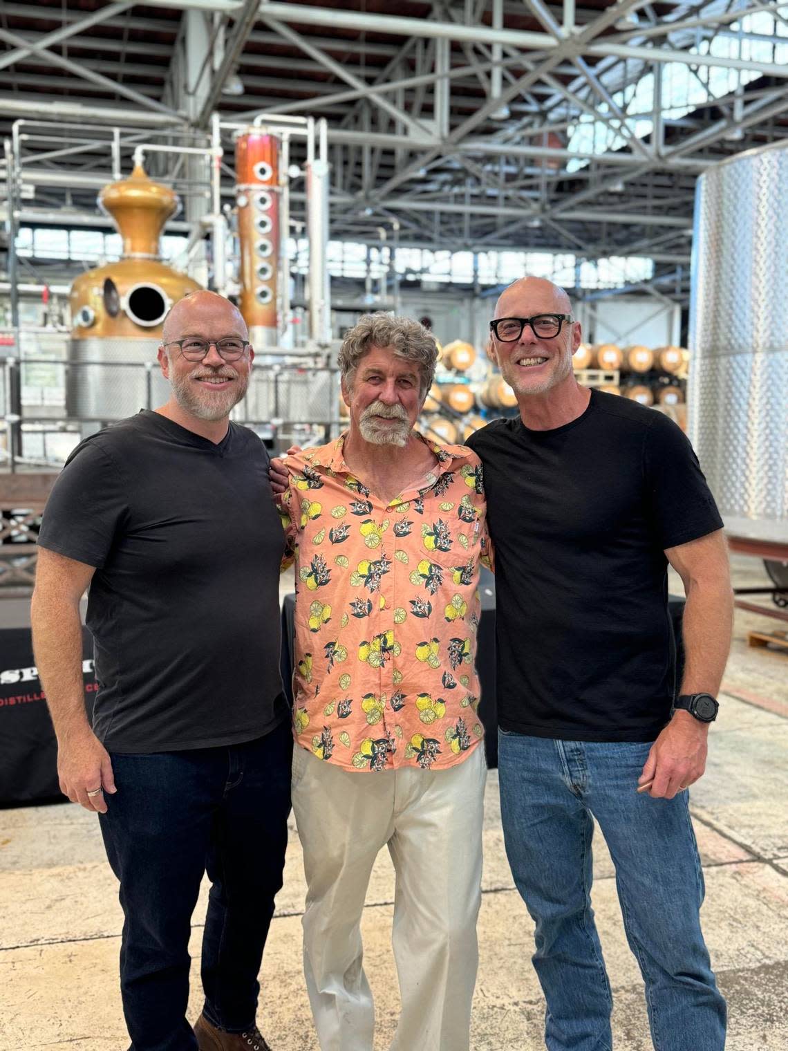 Farmer Greg Kirkpatrick of Lindcove Ranch, middle, poses with St. George Spirits head distiller Dave Smith, far left, and master distiller Lance Winters, far right.