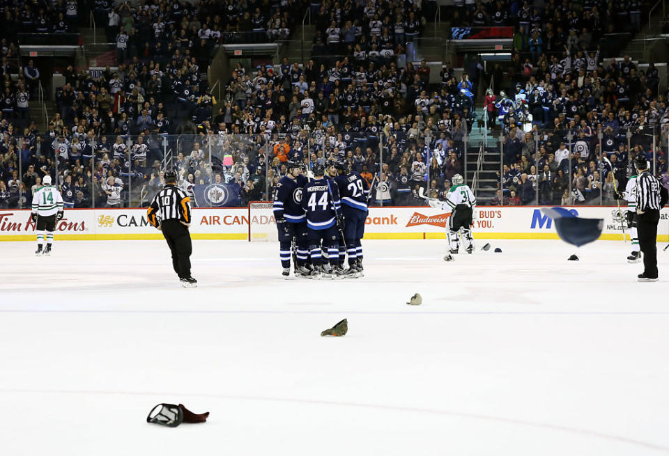 WINNIPEG, MB – FEBRUARY 14: Hats are thrown to the ice as Patrik Laine #29 of the Winnipeg Jets celebrates his third career hat trick, his second against the Dallas Stars at the MTS Centre on February 14, 2017 in Winnipeg, Manitoba, Canada. (Photo by Darcy Finley/NHLI via Getty Images)