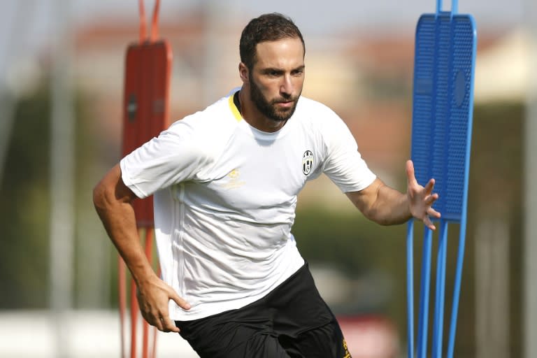 Juventus' Argentinian forward Gonzalo Higuain takes part in a training session on the eve of the UEFA Champions League football match Juventus vs FC Sevilla