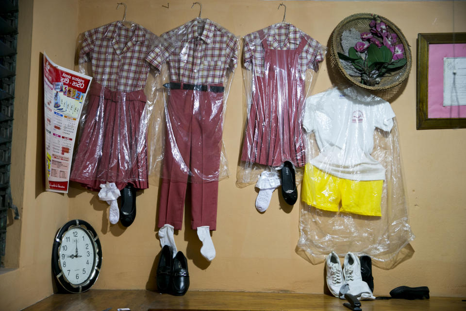 School uniform ensembles are displayed in the Centre Classique Don Bosco school office in Petion-Ville, Haiti, Monday, Dec. 2, 2019. Thousands of Haitian children began to return to school Monday after months of violent unrest forced schools to shut around the country. (AP Photo/Dieu Nalio Chery)