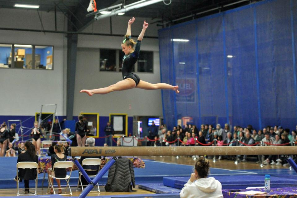 Marshfield's Olivia Audette goes airborne during her balance beam routine at the Patriot League gymnastics meet at Starland in Hanover, Friday, Feb. 9, 2024.