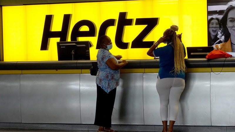 People stand at a Hertz car rental counter in the Fort Lauderdale-Hollywood International Airport on October 25, 2021 in Miami, Florida. Hertz announced that it ordered 100,000 Teslas as the company is emerging from bankruptcy. - Image: Joe Raedle (Getty Images)