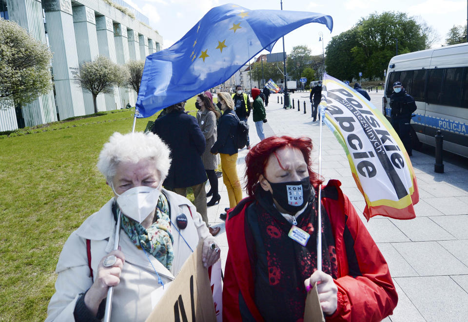 Protesters gather outside the Supreme Court in Warsaw, Poland, Thursday, May 6, 2021. Inside the Disciplinary Chamber of the court was examining the case of a judge. A top European Union legal advisor argued in an opinion Thursday that the chamber for disciplining judges is contrary to EU law.(AP Photo/Czarek Sokolowski)