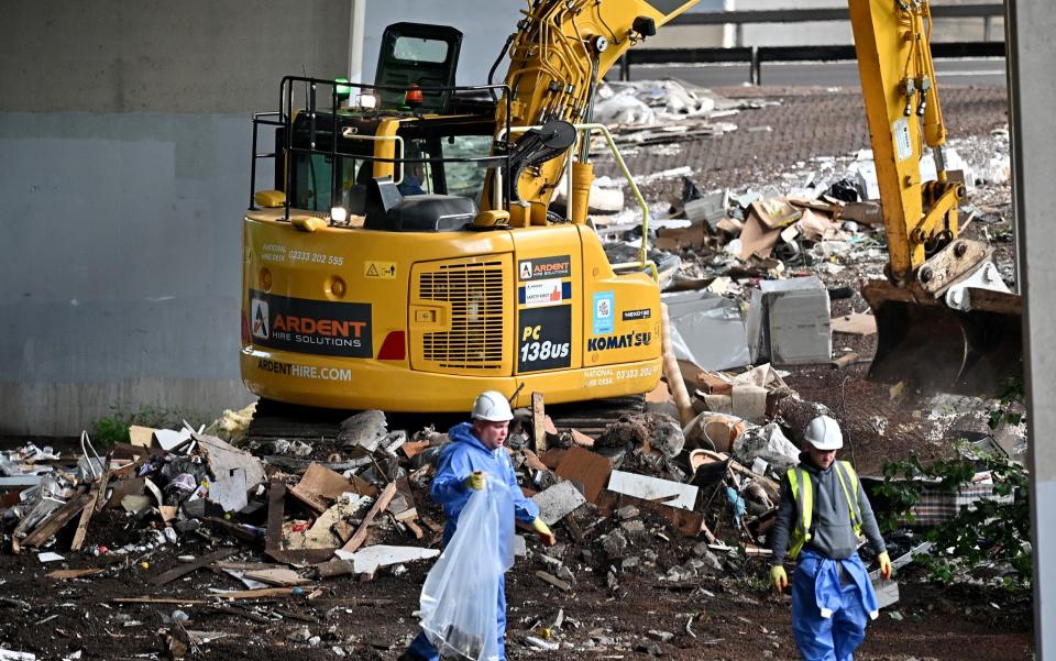 Workers in Glasgow remove rubbish left by fly-tippers under the M8 motorway - Jeff J Mitchell/Getty Images