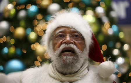 African American Santa Claus Langston Patterson, 77, waits for children to arrive at Baldwin Hills Crenshaw Plaza mall in Los Angeles, California, December 16, 2013. REUTERS/Lucy Nicholson