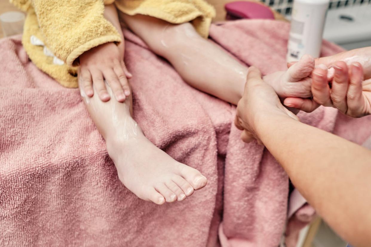 Certain chemicals in synthetic fabrics such as spandex, nylon and polyester can alter the skin microbiome. <a href="https://www.gettyimages.com/detail/photo/mother-rubbing-lotion-on-her-little-daughters-leg-royalty-free-image/1398337060" rel="nofollow noopener" target="_blank" data-ylk="slk:SBenitez/Moment via Getty Images;elm:context_link;itc:0;sec:content-canvas" class="link ">SBenitez/Moment via Getty Images</a>