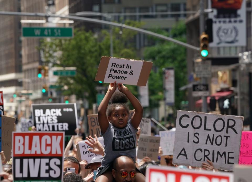 A little girl holds up a sign at a New York protest in 2020 following the death of George Floyd, who died at the hands of a Minneapolis police officer. California’s ethnic studies model curriculum includes lessons on social movements such as Black Lives Matter. (Photo by BRYAN R. SMITH/AFP via Getty Images)