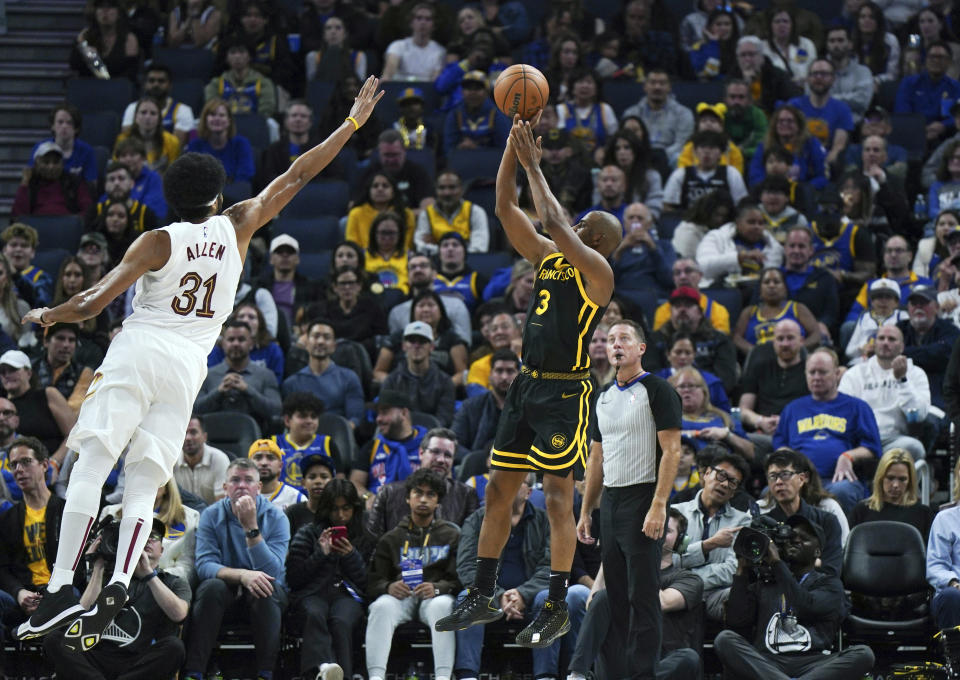 Golden State Warriors guard Chris Paul (3) shoots over Cleveland Cavaliers center Jarrett Allen (31) during the first half of an NBA basketball game Saturday, Nov. 11, 2023, in San Francisco. (AP Photo/Loren Elliott)