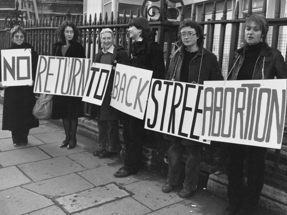 A group of women demonstrating in favour of legal abortions with a banner declaring 'No Return To Backstreet Abortions' circa 1980: Getty Images