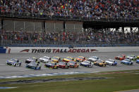 Chase Elliott (9) leads the pack to the start line for a NASCAR Cup Series auto race at Talladega Superspeedway in Talladega, Ala., Sunday, Oct. 13, 2019. (AP Photo/Butch Dill)