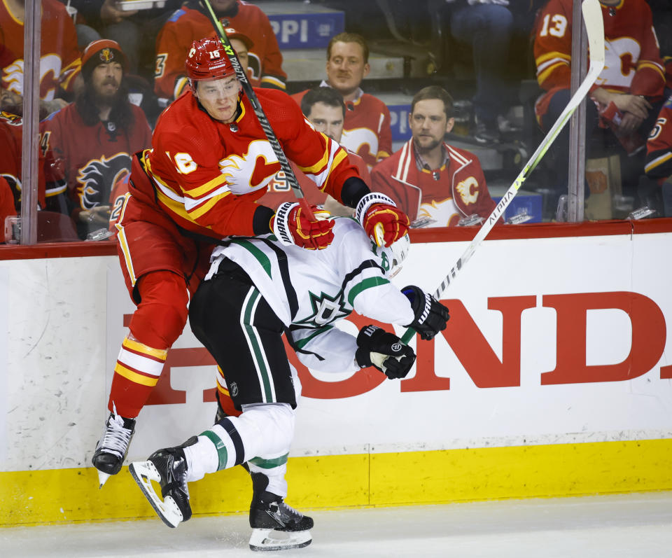 Dallas Stars center Joe Pavelski, right, is checked by Calgary Flames defenseman Nikita Zadorov during the second period of Game 2 of an NHL hockey Stanley Cup first-round playoff series Thursday, May 5, 2022, in Calgary, Alberta. (Jeff McIntosh/The Canadian Press via AP)