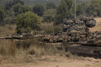 Israeli soldiers with armored vehicles gather in a staging ground near the border with Gaza Strip, southern Israel, May 14, 2021. (AP Photo/Tsafrir Abayov)