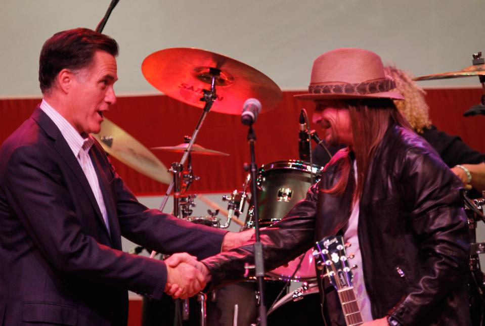 Republican presidential candidate Mitt Romney shakes hands with Kid Rock during a campaign event in Michigan in 2012.