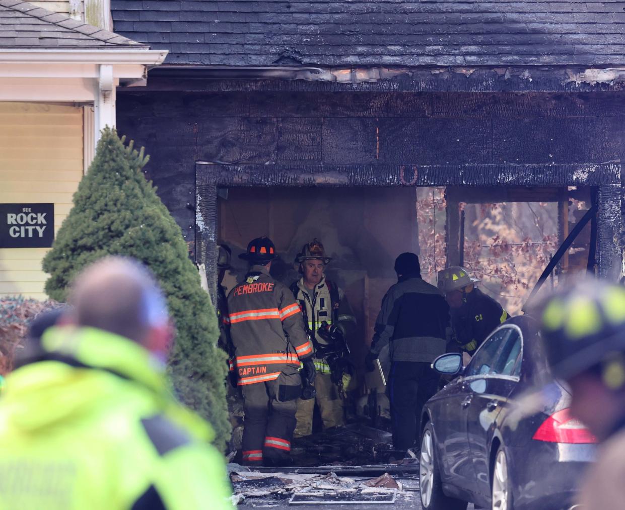 Firefighters survey the damage from a fire at 147 Gray Lane in Hanson on Sunday, Feb. 5, 2023.