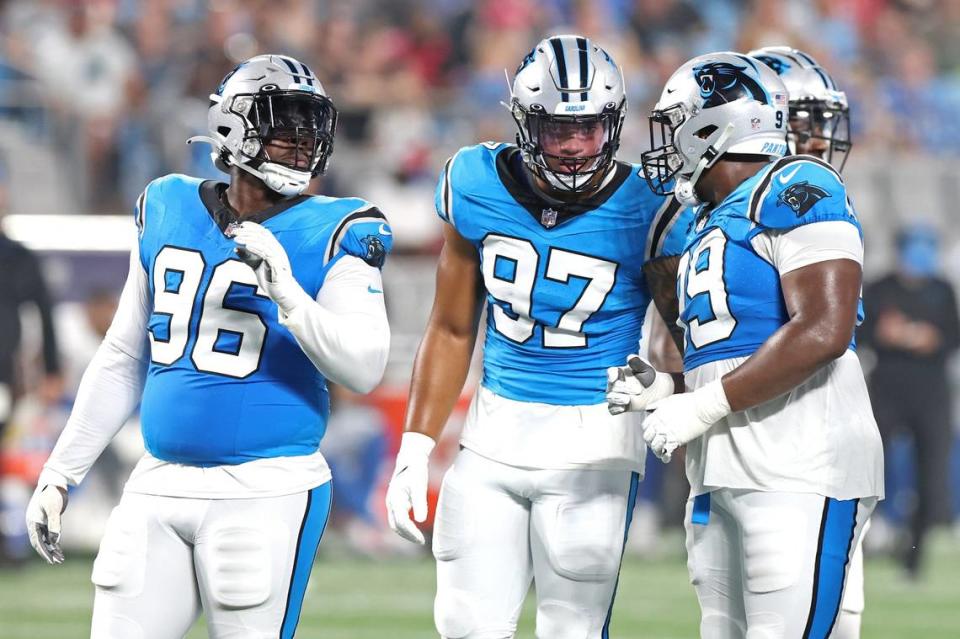 Carolina Panthers defensive end DeShawn Williams, left, linebacker Yetur Gross-Matos, center, and defensive end Shy Tuttle talk prior to a series against the Detroit Lions on Friday, August 25, 2023 at Bank of America Stadium in Charlotte, NC.
