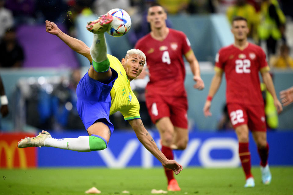 Brazil's forward Richarlison, left, scores the second goal for his team during the World Cup group G soccer match between Brazil and Serbia, at the the Lusail Stadium in Lusail, Qatar on Thursday, Nov. 24, 2022. (Laurent Gillieron/Keystone via AP)