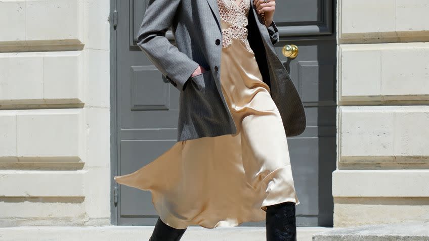 a woman in a coat and sunglasses