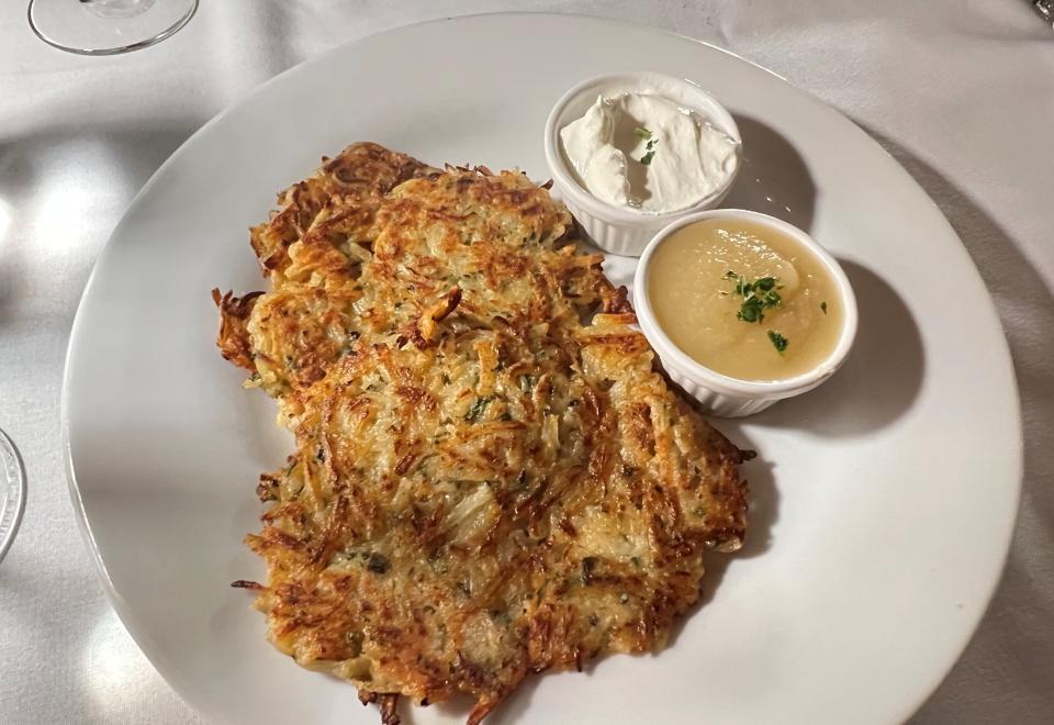 At the Schnitzel Haus in Hobe Sound, the kartoffelpuffer is three crispy potato pancakes alongside sour cream and apple sauce.