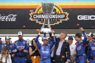 FILE - Kyle Larson, center, celebrates after winning a NASCAR Cup Series auto race and championship on Sunday, Nov. 7, 2021, in Avondale, Ariz. Larson will be a key player in NASCAR's push to widen its reach to a younger and more racially diverse audience. (AP Photo/Rick Scuteri, File)