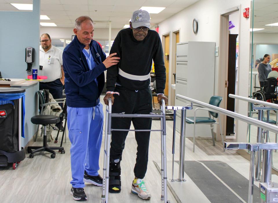 Bishop Bernard Wright relearns how to walk with the help of his occupational therapist, John Mandile, at Delray Medical Center on Monday, Feb. 6, 2023. Wright sustained serious injuries on Monday, Dec. 26, 2022, while leading a vigil in Boynton Beach, his home city.