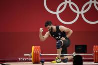 Antonino Pizzolato of Italy gestures after an unsuccessful lift in the men's 81kg weightlifting event, at the 2020 Summer Olympics, Saturday, July 31, 2021, in Tokyo, Japan. (AP Photo/Luca Bruno)