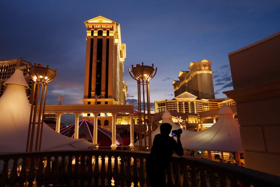 <em>In this Jan. 12, 2015, file photo, a man takes pictures of Caesars Palace hotel and casino in Las Vegas. (AP Photo/John Locher, File)</em>