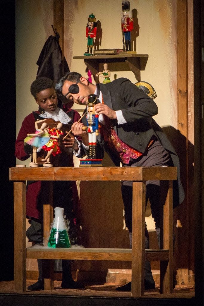 Drosselmeyer puts the finishing touches on the Nutcracker before he presents it to Clara at her parents' annual holiday party.