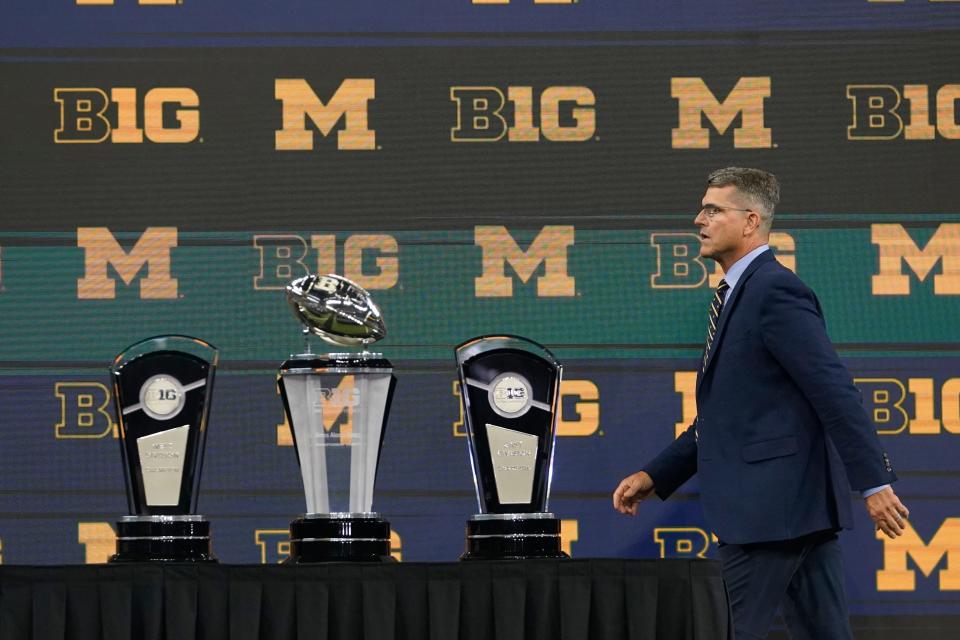 Michigan coach Jim Harbaugh walks the podium during Big Ten media days on Thursday, July 27, 2023, in Indianapolis.