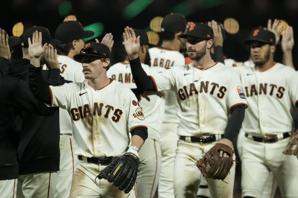 San Francisco Giants players celebrate after the team's 4-1 victory over the Cincinnati Reds in a baseball game Monday, Aug. 28, 2023, in San Francisco. (AP Photo/Godofredo A. Vásquez)