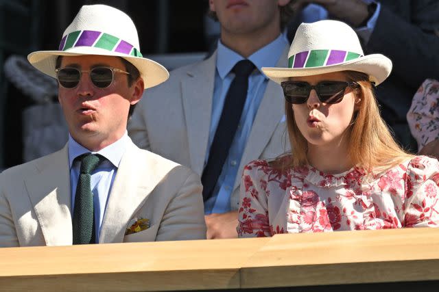 <p>Karwai Tang/WireImage</p> Edoardo Mapelli Mozzi and Princess Beatrice wear hats at Wimbledon in 2022