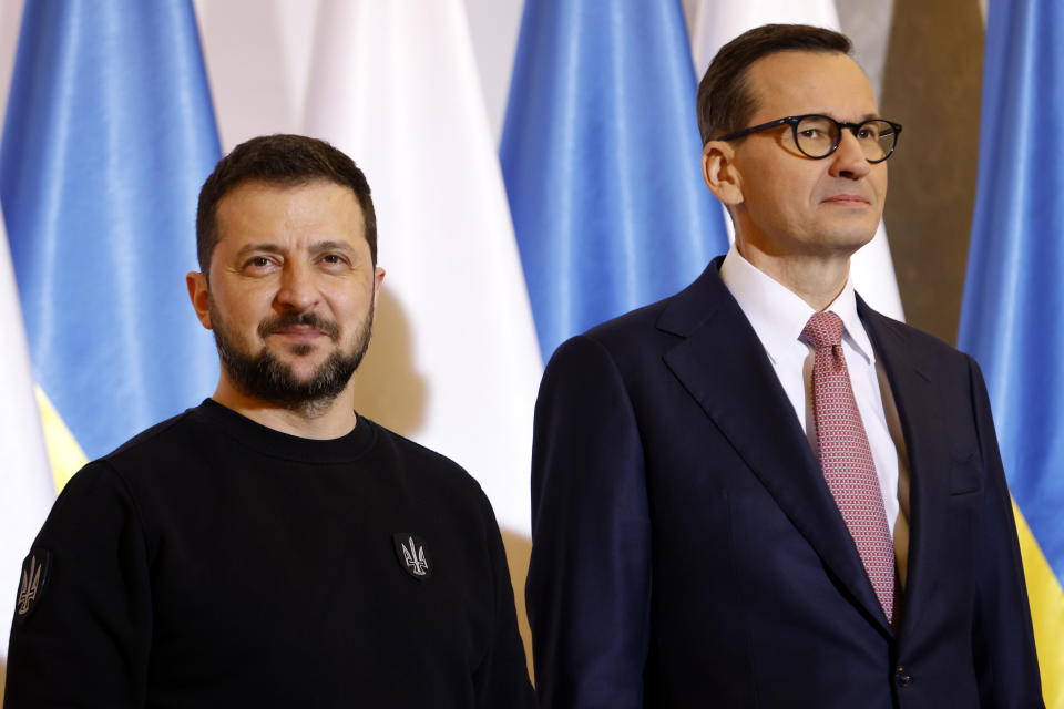 Poland's Prime Minister Mateusz Morawiecki, right, welcomes Ukrainian President Volodymyr Zelenskyy as they meet in Warsaw, Poland, Wednesday, April 5, 2023. (AP Photo/Michal Dyjuk)