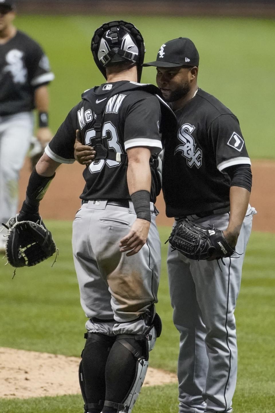 Chicago White Sox catcher James McCann and relief pitcher Alex Colome celebrate after a baseball game against the Milwaukee Brewers Monday, Aug. 3, 2020, in Milwaukee. The White Sox won 6-4. (AP Photo/Morry Gash)