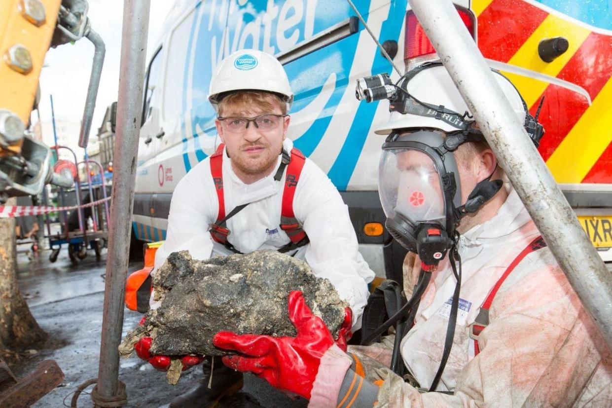 Sam Fishwick with part of the fatberg in a sewer in Whitechapel, east London: Matt Writtle