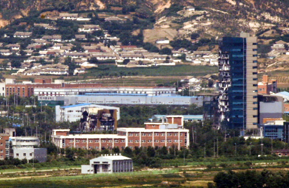 Demolished inter-Korean liaison office building, left, and the severely damaged support center, right, are seen in the Kaesong Industrial Complex in Kaesong, North Korea, in this photo taken from the border area between two Koreas in Paju, South Korea, Friday, June 19, 2020. South Korean President Moon Jae-in on Friday accepted the resignation of his point man on North Korea, who had asked to quit after the North destroyed a liaison office while ramping up pressure against Seoul amid stalled nuclear negotiations with the Trump administration. (Seoul Myung-gon/Yonhap via AP)