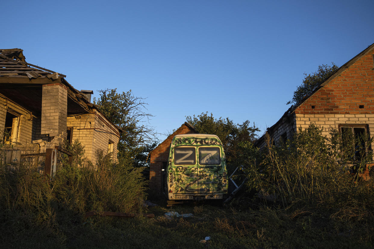 A van with sign "Z" is parked in a residential neighbourhood of the recently retaken area of Kamyanka, Ukraine, Monday, Sept. 19, 2022. Residents of Izium, a city recaptured in a recent Ukrainian counteroffensive that swept through the Kharkiv region, are emerging from the confusion and trauma of six months of Russian occupation, the brutality of which gained worldwide attention last week after the discovery of one of the world's largest mass grave sites. (AP Photo/Evgeniy Maloletka)