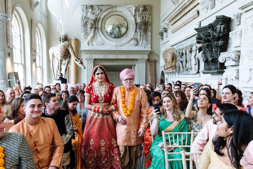 Walking into the orangerie for the Hindu ceremony with my dad. I had been hidden upstairs until that point. One of our two walks down the aisle that weekend.