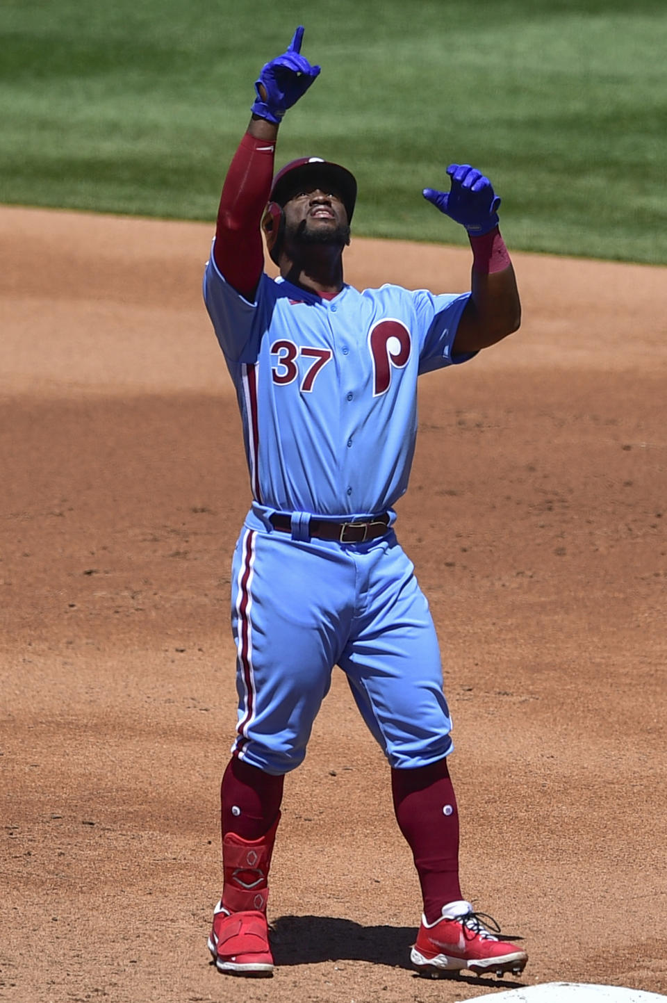 Philadelphia Phillies' Odubel Herrera points to the sky after hitting a single off Milwaukee Brewers starting pitcher Brandon Woodruff during the second inning of a baseball game, Thursday, May 6, 2021, in Philadelphia. (AP Photo/Derik Hamilton)