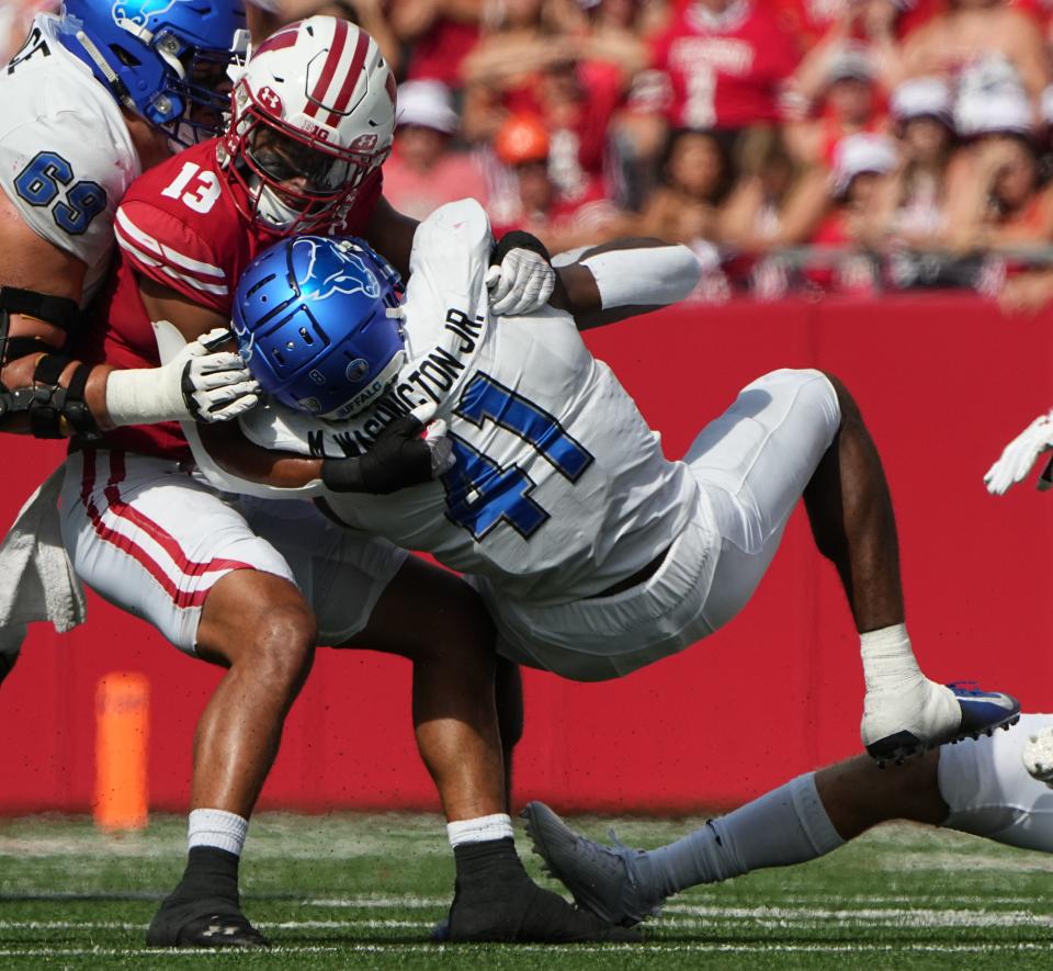 Wisconsin cornerback Jason Maitre drills Buffalo running back Mike Washington during the second quarter Saturday. Overall, UW's defense was especially strong on third down, holding the Bulls to two third-down conversion in 15 tries (13.3%).