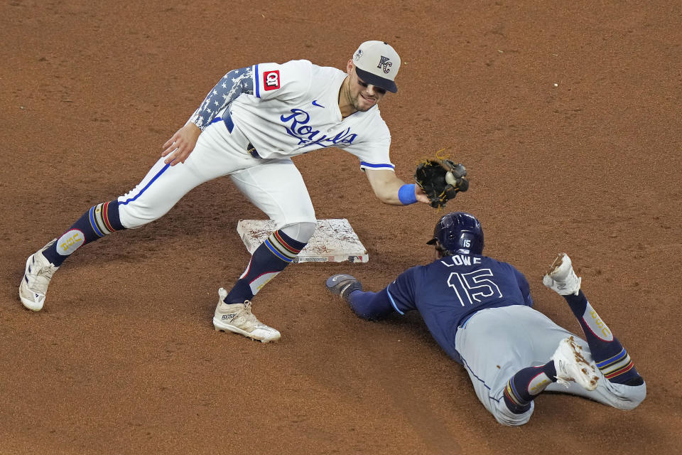 Tampa Bay Rays' Josh Lowe (15) beats the tag by Kansas City Royals second baseman Michael Massey to steal second during the fifth inning of a baseball game Thursday, July 4, 2024, in Kansas City, Mo. (AP Photo/Charlie Riedel)
