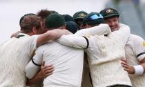 Australia's team celebrate after taking the wicket of England's Monty Panesar as a last wicket and winning the second Ashes cricket test at the Adelaide Oval December 9, 2013. Australia captured England's four remaining wickets before lunch to close out an emphatic 218-run victory in the second Ashes test on Monday. REUTERS/David Gray (AUSTRALIA - Tags: SPORT CRICKET)