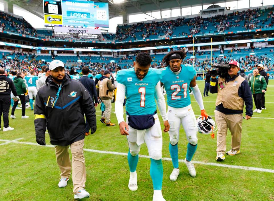 Miami Dolphins quarterback Tua Tagovailoa (1 ) and Miami Dolphins safety Eric Lowe, 21, leave the field. Gardens, Florida.  (David Santiago/Miami Herald/Tribune News Service via Getty Images)