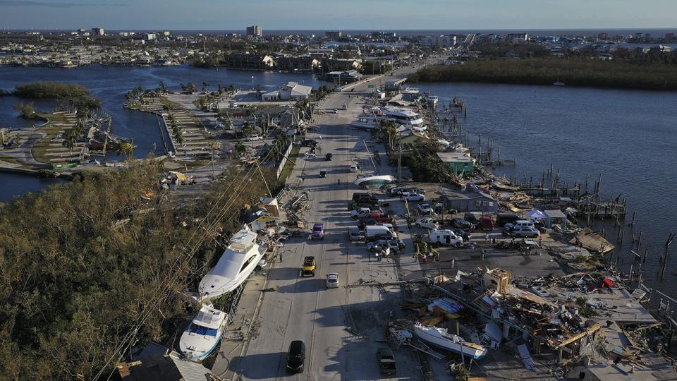 In this aerial view, boats sit grounded in a woodland area and along the side of the road after being pushed by rising water from Hurricane Ian near Fort Myers Beach on September 29, 2022, in San Carlos Island, Florida.