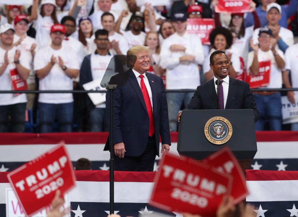 President Donald Trump, left, brought candidate for Kentucky attorney general Daniel Cameron up to the stage after he made remarks supporting him at Rupp Arena in Lexington, Ky. on Nov. 4, 2019.  