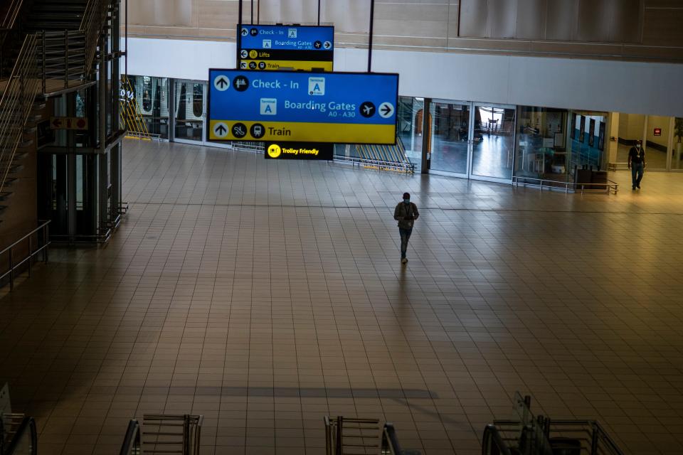 A man walks through a deserted part of Johannesburg's OR Tambo's airport in South Africa on Nov. 29, 2021.