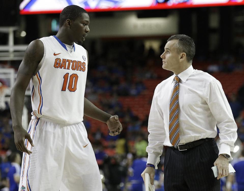 Florida head coach Billy Donovan speaks to Dorian Finney-Smith (10) during the second half of an NCAA college basketball game against Kentucky in the Championship round of the Southeastern Conference men's tournament, Sunday, March 16, 2014, in Atlanta. (AP Photo/Steve Helber)