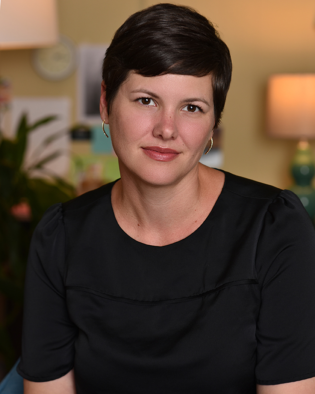 woman with short pixie hair cut and black blouse