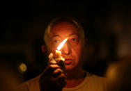 <p>A man holds a candle outside the Instituto Politecnico, a technical high school, where the five Argentine citizens who were killed in the truck attack in New York on October 31 went to school, in Rosario, Argentina, Nov. 1, 2017. (Photo: Marcos Brindicci/Reuters) </p>