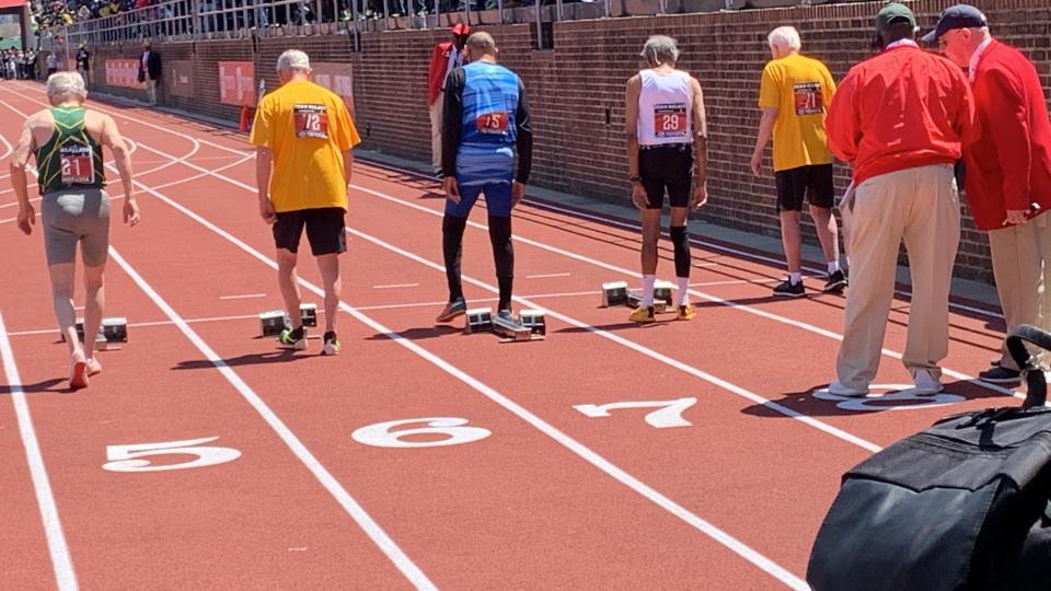 Long Branch 100-year-old Lester Wright (second from right, white shirt) gets ready for the start of the master's 100-meter dash at the Penn Relays