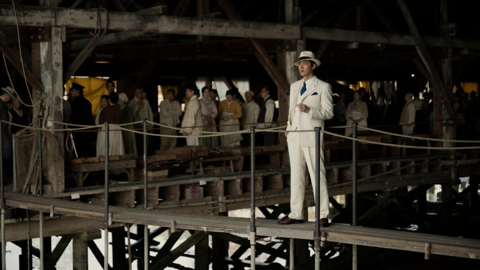 The dapper and ambitious new fish broker Hansu (Lee Min-ho) surveys the market in the Korean village where he has been dispatched. - Credit: Courtesy of Apple TV+