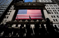 People walk past the New York Stock Exchange on Wednesday, June 29, 2022 in New York. Stocks shifted between gains and losses on Wall Street Wednesday, keeping the market on track for its fourth monthly loss this year. (AP Photo/Julia Nikhinson)